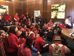 Activists with Oregon Rising Tide sit in at Gov. Kate Brown's office Thursday, Nov. 21, 2019, in Salem, Ore., demanding she come out against the Jordan Cove LNG project on the coast.