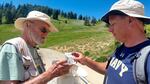 Robbin Thorp helps Brendan White identify a bumblebee on Mount Ashland.