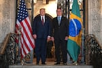 President Trump (left) speaks with then-Brazilian President Jair Bolsonaro during a dinner at Mar-a-Lago in Palm Beach, Fla., on March 7, 2020.