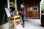A woman named Hilary signs for her food to-go at Walking Man Brewing Company in Stevenson, Wash., Thursday, May 14, 2020. Skamania County was one of the first counties in Washington to partially reopen amid the COVID-19 pandemic.