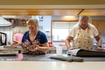 Volunteers Carrie Starks, left, and Laurel Buhler work in the kitchen at James 2 Community Kitchen.