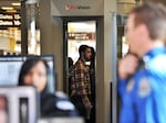 A passenger goes through a full-body scanner at Reagan National Airport in Washington, D.C., on Nov. 24, 2010.