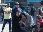 Palestinians mourn after the Israeli strike at Nuseirat Refugee Camp on Wednesday.