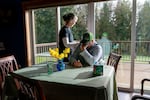 Rebecca Zuber comforts her husband Randy, on the 5th anniversary of their daughter Sarah’s death, at their home in Rainier, Ore., March 13, 2025. 