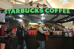 FILE - Shoppers at the Walden Galleria in Buffalo, NY, stop by the Starbucks kiosk on Nov. 30, 2024.