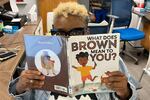 Children's librarian Stacie Madkins looks at books for story time at the Craighead County Jonesboro Public Library. Because of funding cuts, local libraries are slashing spending and staff. Some branches might have to close.