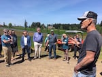 David Nemarnik talks with a group of tour-goers about the solar panels on his 34-acre vineyard.