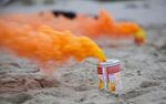 Students set off smoke cannisters on the beach. A smoke plume can make the difference between being seen or unseen during a search.