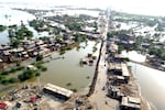 Homes are surrounded by floodwaters in Sohbat Pur city of Jaffarabad, a district of Pakistan's southwestern Baluchistan province, Aug. 29, 2022. The U.N. weather agency predicts the phenomenon known as La Nina is poised to last through the end of this year — its third year in a row — and affect meteorological patterns like drought and flooding worldwide.
