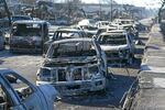 August 11: Burnt out cars line the sea walk after the wildfire in Lahaina.