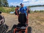 Kirk Mickelsen, with David's Chair, demonstrates the track chair at an event near Mount Pisgah.