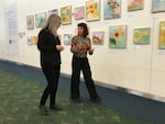 Renée Zangara and PDX Art Program Curator Wendy Given discuss Zangara's "State Flowers at PDX" installation.