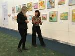 Renée Zangara and PDX Art Program Curator Wendy Given discuss Zangara's "State Flowers at PDX" installation.