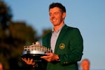 Rory McIlroy, of Northern Ireland, holds the trophy after winning the Masters golf tournament at the Augusta National Golf Club, Sunday, April 12, 2026, in Augusta, Ga.