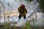 A provided image showing a firefighter working near Northwest Seekseequa Creek Road near Warm Springs, Ore. on July 28, 2026.