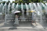 Visitors pass by the cooling fog device at Gwangmyeong Cave tourist site in Gwangmyeong, South Korea, Aug. 6, 2026.