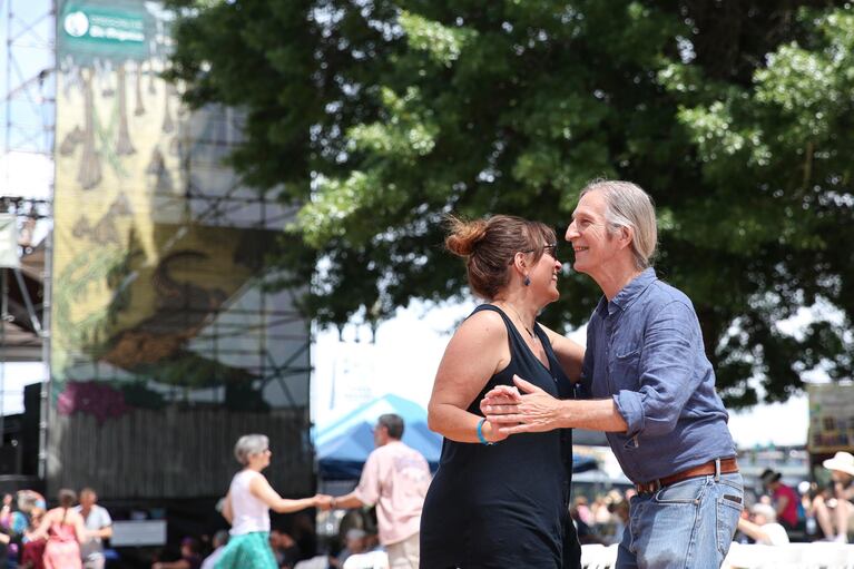 A man and woman get lost in the music together on the Front Porch Stage dance floor.