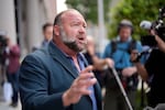 Right-wing conspiracy theorist Alex Jones speaks to the media after arriving at the federal courthouse in Houston for a bankruptcy hearing in June.