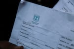 An Indian man holds up a registration form to work in Israel. He was recently at a registration office in the northern Indian city of Lucknow after two Indian states, Haryana and Uttar Pradesh, recently announced they were seeking to recruit 10,000 skilled laborers each to Israel.