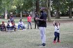 Sam Thompson, founder of Black Men and Women United, speaks to members of the Black community during a weekly meeting as his 3-year-old son, Jet, plays behind him in Portland, Ore., on Wednesday, Aug. 12, 2020. Thompson founded the group amid the ongoing protests in Portland with the goal of bringing long-term resilience to the city's Black community, which has endured years of racism.