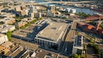 An aerial view of the area of Northwest Portland, Ore., encompassing the Broadway Corridor. The old USPS building is in the center, with Union Station in the top right corner.