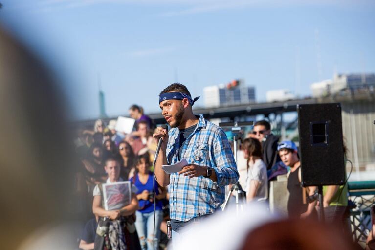 Portland's Resistance organizer Gregory McKelvey speaks to a crowd gathered at the Salmon Street Springs Fountain. He said the goal of the march was to counter President Donald Trump's response to the events in Charlottesville.