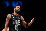 Brooklyn Nets guard Kyrie Irving (11) gestures during the first half of the team's NBA basketball game against the Toronto Raptors on Friday, Dec. 2, 2022, in New York.