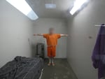 In this supplied image, an incarcerated person stands with their arms stretched out inside a cell used for solitary confinement. On June 11, 2026, a group of incarcerated people filed a class-action lawsuit, arguing Oregon's prison system is violating the state Constitution, which prohibits the “harsh, degrading, or dehumanizing treatment of prisoners.”
