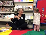 FILE - In this April 7, 2017, photo, children's librarian Chere Brown reads to toddlers during a story time at the main Josephine County library branch in Grants Pass, Ore.