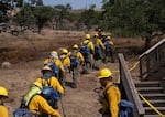 National Guard crews create fire lines around a home near Pine Hollow, Ore., on Aug 14, 2026.
