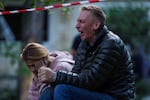 A father cries as his son is under the rubble of a multi-story residential house destroyed by a Russian strike in Kyiv, Ukraine, on Tuesday.