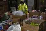 Chris Drake (left) packs bags of supplies to be distributed to Portland’s unhoused community on March 25, 2020 in Portland, Oregon. Street Roots’ is coordinating an outreach program distributing hygiene supplies and coronavirus information to Portland’s unhoused community. 