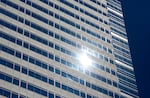 The sun glints off a building during the hottest part of the day in downtown Portland, Ore. on July 9, 2024. After several days of above average heat, the temperature in Portland reached triple digits on Tuesday. 