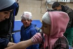 Palestinian children wounded during the Israeli bombardment of the Gaza Strip receive treatment at the Al-Aqsa Hospital in Deir al-Balah, Tuesday, Jan. 14, 2025.