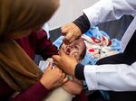 A nurse administers polio vaccine drops to a young Palestinian patient at the Nasser hospital in Khan Yunis in the southern Gaza Strip on Saturday amid the ongoing conflict between Israel and the Hamas militant group. 