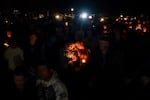 People mourn during a candlelight vigil at Drake Park after three children and a teacher were killed in a shooting at Silver Rail Elementary School in Bend, Ore. on Oct. 15, 2026. 