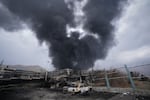 March 8: A thick plume of smoke rises from an oil storage facility hit by a U.S.-Israeli strike late Saturday in Tehran, Iran 