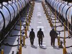 Workers prepare oil trains for unloading at the Tesoro Refinery north of Seattle.