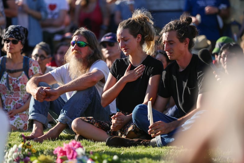 Family members of one of the victims sat together at the center of the circle.