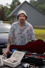 Forest Anderson has been traveling across Vermont doing cybersecurity assessments of different systems. Here he stands with some of the devices he's been able to procure and assemble that have the potential to cause cybersecurity issues.