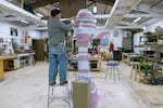 Sculptor Scott Foster works on his sculpture, "The Watcher" on Nov. 11, 2021. The 8-foot tall sculpture can be found in Lake Oswego as part of the Gallery Without Walls showcase.