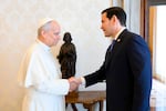 Pope Leo XIV greets U.S. Secretary of State Marco Rubio, right, upon his arrival for talks in the pope's private library at the Vatican.