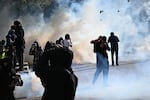 Protesters scuffle with police during a demonstration against rising living costs, joining students' grievances, in Paris on Saturday.