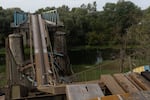 A collapsed bridge over a river in Izium. Ukrainian armed forces estimate 80% of the city is ruined from the violence.