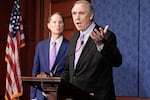 Sen, Jeff Merkley, D-Ore., right, speaks during an event at the Capitol, Wednesday, July 30, 2025, in Washington, as Sen. Ron Wyden, listens.