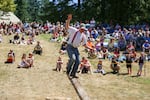 Buckley native Jeff Fetter runs across an elevated log with his chainsaw in the obstacle pole competition. In this event, the objective is to run across the log, saw off the edge of it, and race back the fastest.