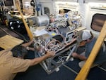 Researchers work on instruments inside a specially outfitted plane.