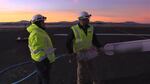 After working through the night, Near Space Corporation President Kevin Tucker (right) holds onto a diffuser at the junction of the air hose and inflation tube.