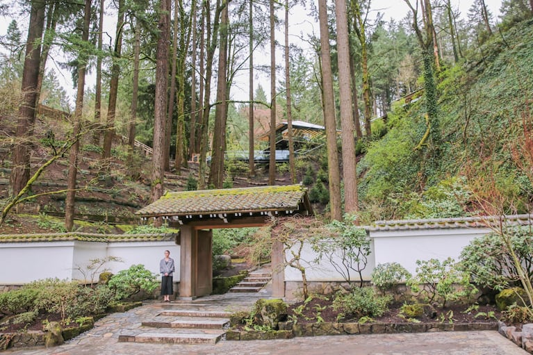 Perched above the garden's ancient gate, a glass building (home to the garden's new Umami Café) glints among the trees.
