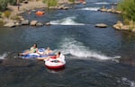 Inner tubes collide in a rapid of the Bend Whitewater Park on August 9, 2023.
